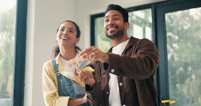 Smile, couple and talking at new house with swatches, paint sample and ideas for interior design. People, pointing and planning in home with color palette, renovation and diy makeover for remodeling