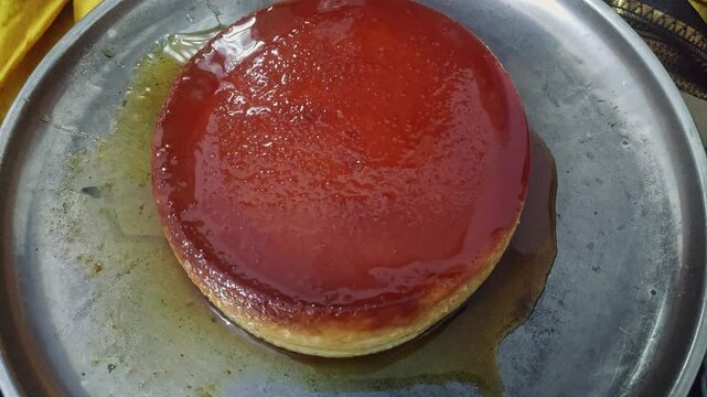 Closeup view of caramel flan dessert showing smooth texture and glossy caramel topping