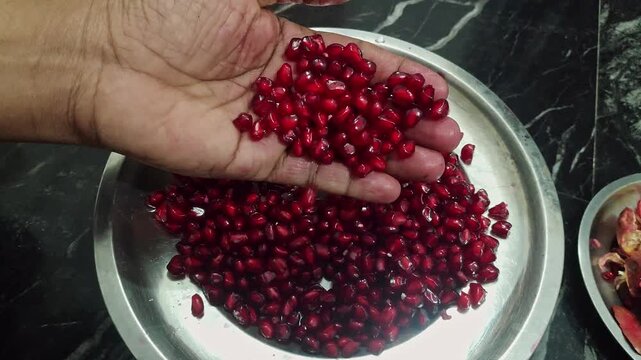 Closeup view of pomegranate arils showing juicy red seeds and fresh fruit texture
