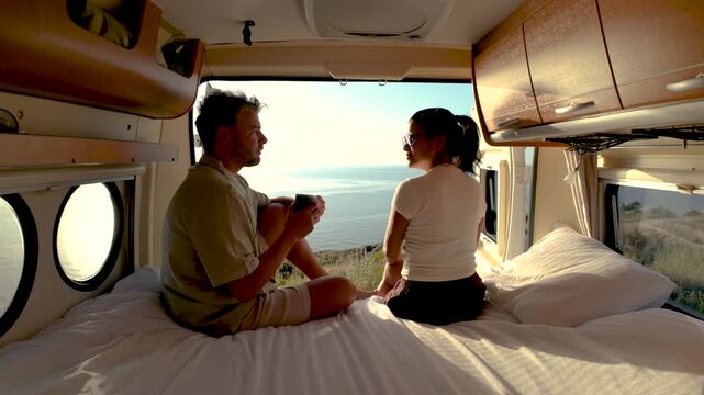 A couple enjoys a peaceful moment together in their cozy van, overlooking the stunning views of Chalkidiki Greece. They share laughter and warmth, wrapped in the beauty of nature.