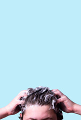 Naklejka premium Woman Washing her hair with shampoo foam isolated on blue background. Symbol of hair care. Treatment and health related theme.