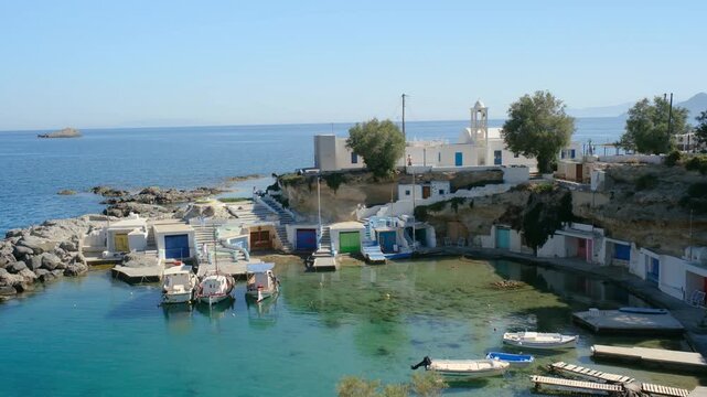 Discover the breathtaking charm of Mandrakia Milos Island, Greece, featuring crystal-clear waters and colorful fishing boats nestled in picturesque coves