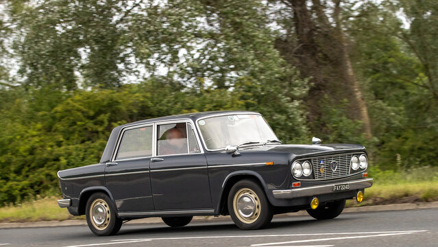 Stony Stratford,Bucks,UK - June 7th 2026:1966 Lancia Fulvia classic  car driving on a British road