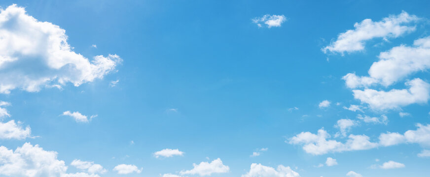 Soft clouds drift across a vivid blue sky