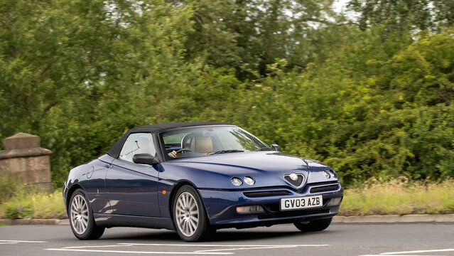 Stony Stratford,Bucks,UK - June 7th 2026:  2003 blue Alfa Romeo Spider car driving on a British road