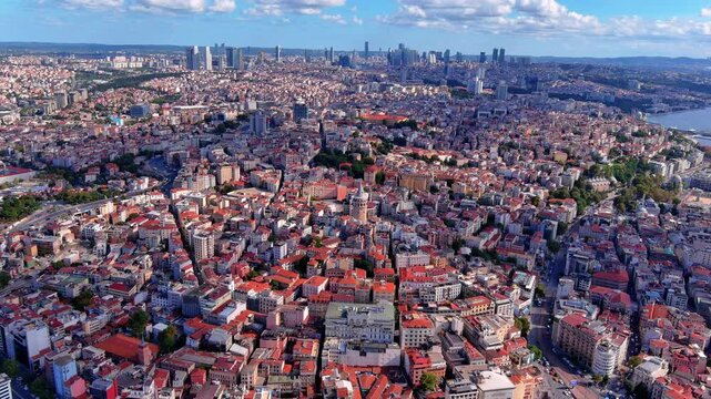 4K aerial drone footage over Istanbul, Turkey - Galata Tower, Beyoğlu district, Golden Horn waterway, Bosphorus Strait, Karak&ouml;y, and modern CBD skyscrapers on the horizon.