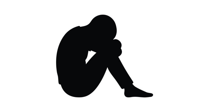 Silhouette of a sad person sitting alone