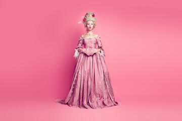Photo of lady princess in renaissaince era wearing baroque style dress isolated pastel color background © deagreez