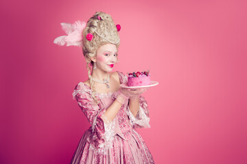Fototapeta premium Photo of charming positive marie antoinette wear rich dress eating birthday cake empty space isolated pink color background
