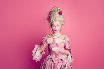 Fototapeta premium Photo of happy attractive lady dressed baroque costume enjoying tea copy space isolated pink color background