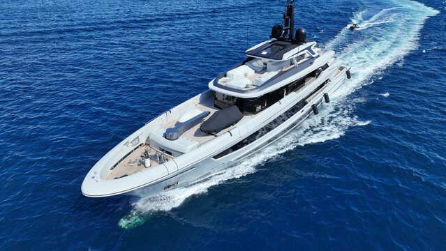 Aerial drone photo of luxury yacht cruising in deep blue open ocean Aegean Sea