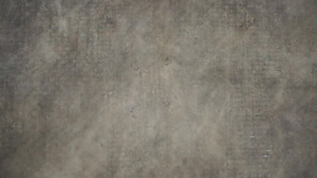 Top view of smooth gray polished concrete floor texture with subtle panning movement