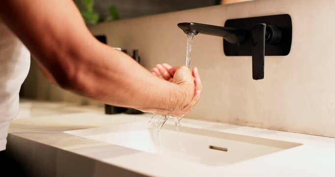 Foam, sink and washing hands with man in bathroom of home for disinfection or hygiene. Basin, cleaning and soap with person in apartment to remove bacteria or germs for morning self care routine