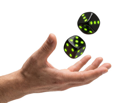 Hand throwing two black dice with green glowing dots, chance concept