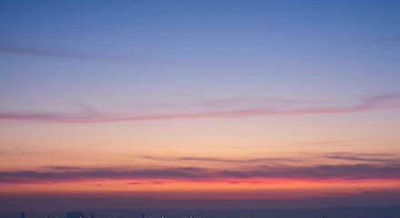 Fototapeta premium Vivid twilight sky capturing a serene moment as colors gently shift from soft blue to warm orange and fiery red. AI Generated