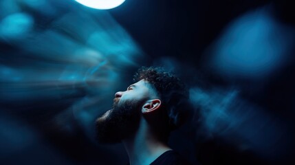 Fototapeta premium A distressed man screams with motion-blurred faces in a dark blue cinematic setting. Dramatic lighting highlights intense emotion and mental health turmoil.