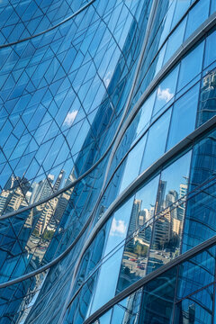 Modern Glass Skyscraper Facade with City Reflections Background