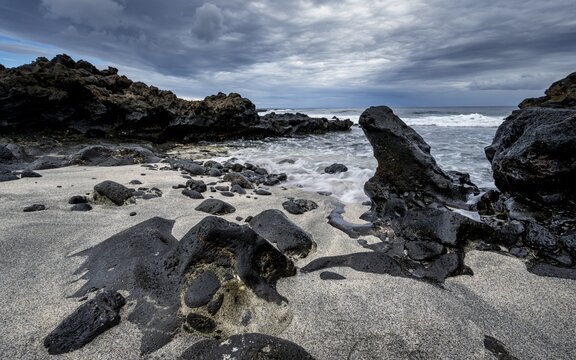 Waves blaze on the beach, rocky coast with volcanic stones, long exposure, Playa de la Peque&ntilde;a, Punta Usaje, Lanzarote, Canary Islands, Spain