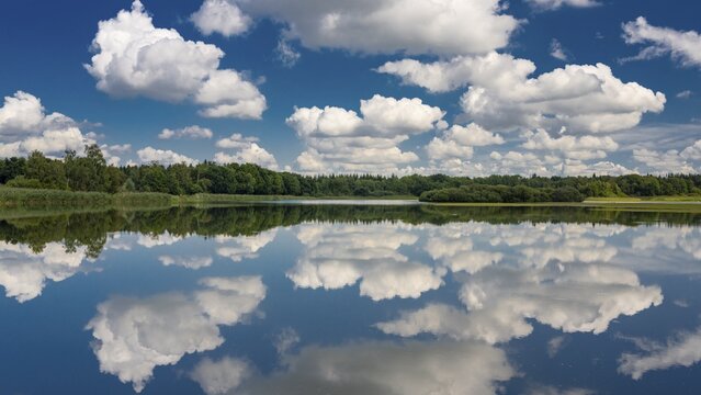 Cumulus clouds over Ahlhorn fish ponds, Ahlhorn, Lower Saxony, Germany