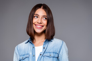 Obraz premium Smiling young woman in denim shirt looking to the side with bright, cheerful expression casual portrait photograph