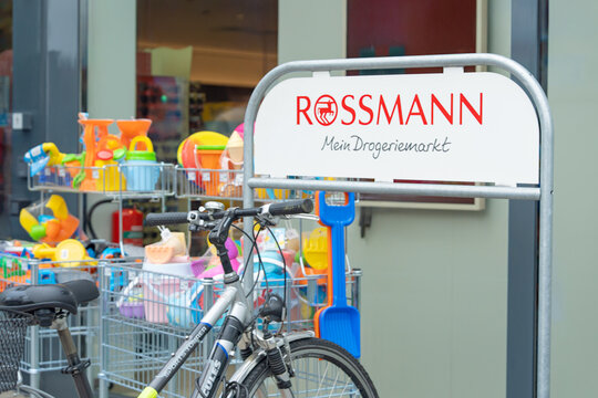Bad Hersfeld, Germany, 06.05.2026, Rossmann drugstore sign with bicycle outside. Store entrance with street retail display.
