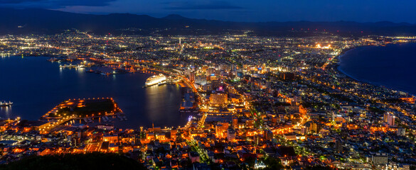 Obraz premium Night view of Hakodate from Mount Hakodate, one of Japan's three famous night views, Hokkaido, Japan. Spectacular night view of Hakodate city seen from Mount Hakodate in Hokkaido, Japan. 