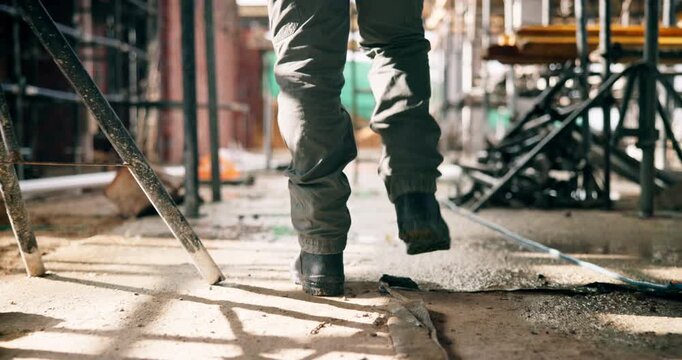 Construction, walking or legs on site with inspection, safety check or quality control in building project. Back, man or engineer with boots, progress track or evaluation in industrial compliance.
