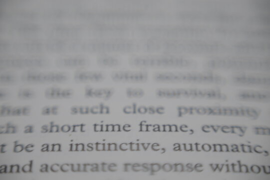Book letters close up zoomed in black text on white paper macro