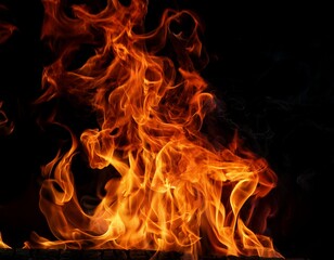 Fototapeta premium intense flames of a fire against a black background the vibrant flames flicker and dance creating a mesmerizing display of heat and energy