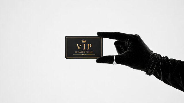 Luxury VIP membership card held by elegant black velvet gloved hand isolated on white background