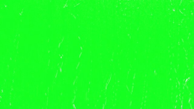 Condensation drops on window green screen chroma key background overlay with stormy autumn rain falling down for advanced multi layer film editing software compositing video layouts.........