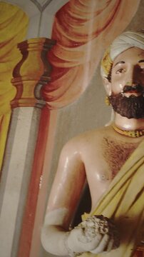 Elegant Statues Surrounded by Stunning Temple Mural Works