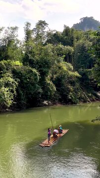 Nature lovers discover Khao Sok, Thailands stunning landscapes while bamboo rafting on peaceful waters. Lush greenery and vibrant local life create an unforgettable experience in paradise.