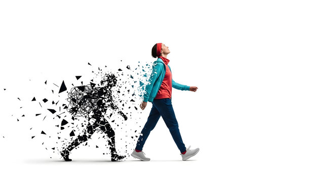 Woman walking away from dissolving dark silhouette, symbolizing freedom and new beginnings
