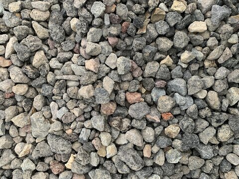 Close-up of crushed stones used as aggregate for construction, roadwork, drainage systems, and concrete production.