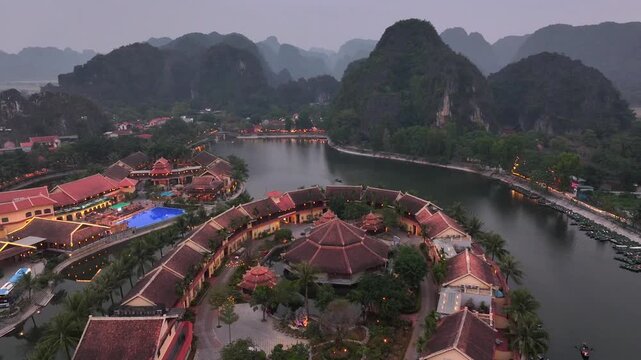 Aerial view of Tam Coc, a Historic Old Town Island in evening, Surrounded by Carst Mountains in Ninh Binh, Vietnam.
