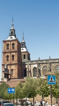 ASTORGA, SPAIN - August 2025: Vertical view of the towers and side facade of Astorga Cathedral in Le&oacute;n, Spain. Historic Gothic religious architecture against a clear blue sky.