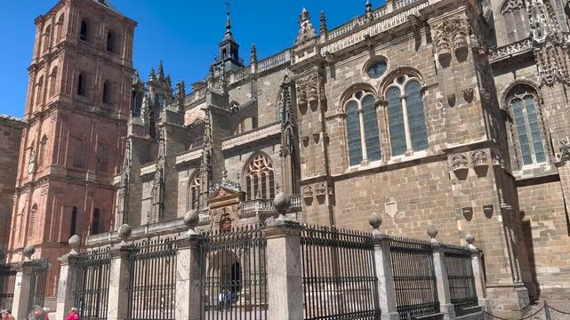 Detailed architectural view of the Gothic facade and bell tower of Astorga Cathedral in Le&oacute;n, Spain. Historic religious landmark featuring ornate stonework and medieval architectural elements.