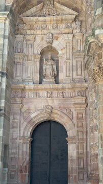 Vertical architectural detail of the ornate portal of Astorga Cathedral in Le&oacute;n, Spain. Historic stone entrance featuring religious sculpture, arches and decorative Renaissance and Gothic elements.