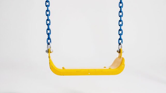 An empty yellow swing with blue chains isolated on a clean white background.