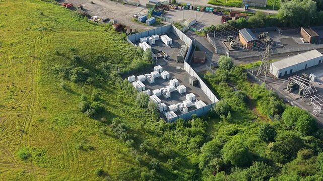 Overview of Modular BESS Battery Energy Storage System with Lithium-ion Containers near Substation. Grid management, AI energy optimization, and sustainable infrastructure. UK. 4K.