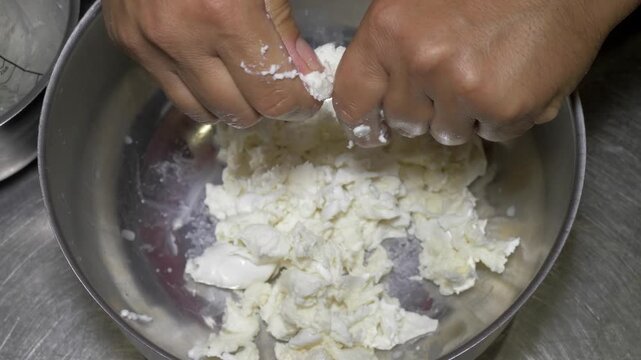 Traditional Apulian burrata is handmade by skilled hands, highlighting artisanal dairy production and Italian food traditions.
