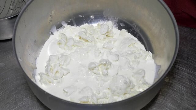 Fresh cream is added during burrata preparation, an essential step in creating the creamy filling of this Italian cheese.