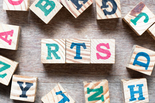 Alphabet letter block in word RTS (abbreviation of return to sender, real time strategy, ready to ship or request to send) and another letter on wood background