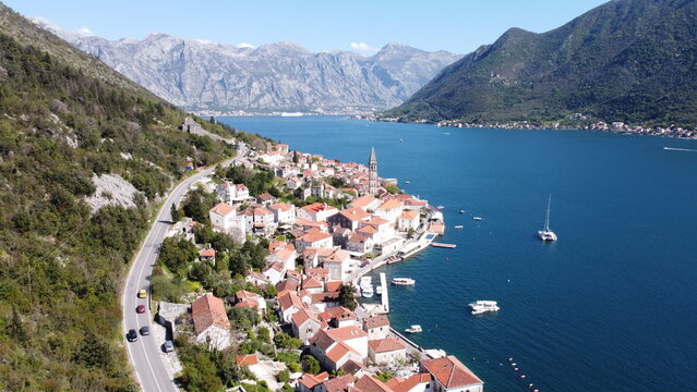 Cinematic aerial view of Perast city and Our Lady of the Rocks island in the Bay of Kotor, Montenegro