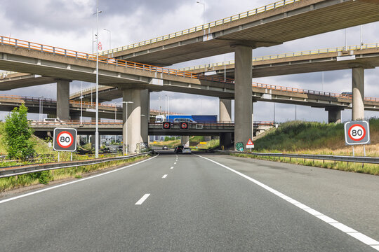 Den Haag, Netherlands - June 03, 2026: Concrete multi-layer flyover bridges at the Prins Clausplein highway interchange with speed limit signs.