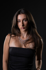 Fototapeta premium Female model posing in a studio, showcasing beauty, fashion, and glamour