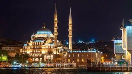 Istanbul, Turkey - June 12, 2026: Night view of Yeni Camii, also known as the New Mosque, in Istanbul, Turkey, showing the illuminated Ottoman mosque, domes, and minarets. © batkanov