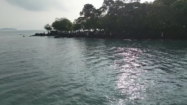 Low Aerial Of Rocky Mangrove Islet On Calm Hazy Sea Lampung