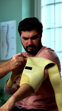 Indian physiotherapist treating young patient for neck and shoulder pain during physical therapy session as experienced male therapist provides manual treatment inside modern Indian clinic